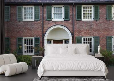 Front of old two story brick house with shutters around windows Wall mural