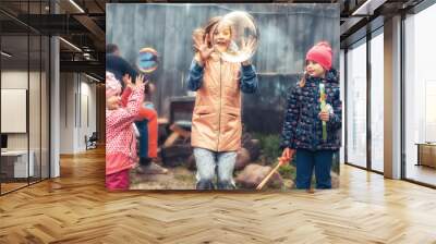 Happy children different ages having fun together outdoors in countryside symbolizing happy carefree childhood lifestyle Wall mural