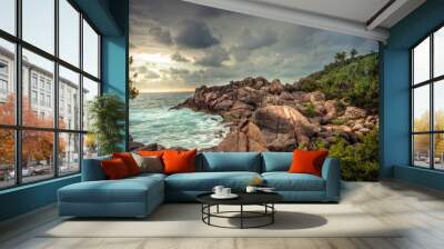 Rocky beach sea lagoon tropical scenery with palm trees and round stones with dramatic sunset sky vibrant colors in Sri Lanka Wall mural