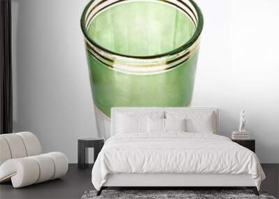 Old glass of peppermint tea isolated on white background Wall mural