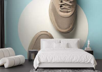 Beige sneakers on a white circles. Blue background. Creative idea. Fashion concept. Top view Wall mural