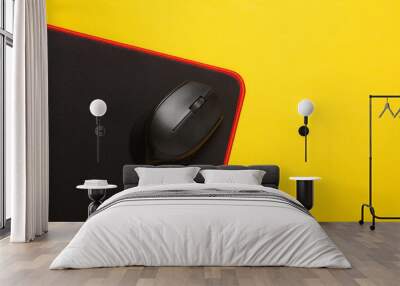 Black PC mouse with PC mouse pad on a yellow background Wall mural