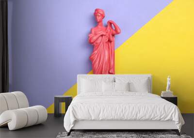 Creative layout. Pink Antique greek goddess statue on purple yellow background. Flat lay. Top view Wall mural