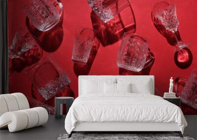 Drink glasses with shadow on red background. Top view. Minimalism, creative layout Wall mural