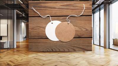 Empty round craft and white paper price tags with string on wooden background. Template for design Wall mural