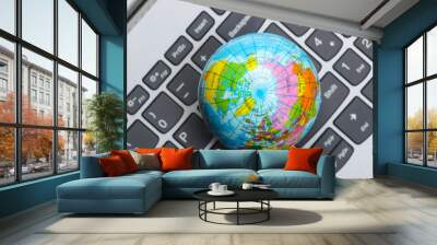 Global network. Globe on a laptop keyboard closeup. Online communication Wall mural