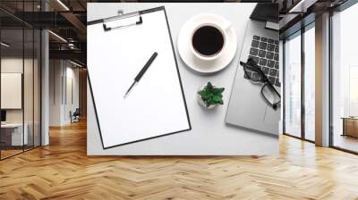 Laptop, Clipboard with a blank sheet of paper and coffee cup, office accessories on gray background. Flat lay Wall mural