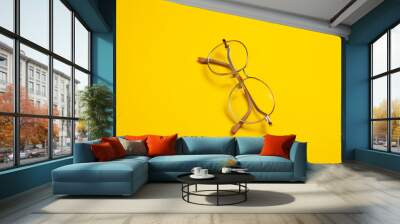 Optical eye glasses on yellow background Wall mural