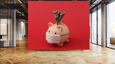 Piggy bank in medical mask with banknote on red background. Economic disease. Financial crisis. Covid-19 pandemic Wall mural