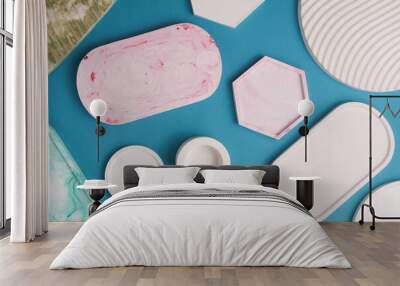 Plaster geometric shapes, decorative trays on blue background. Top view Wall mural