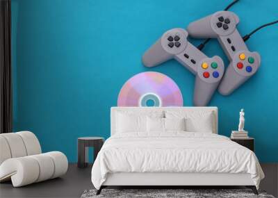 Retro gamepad and CD's on blue background. Gaming, video game competition. Top view Wall mural