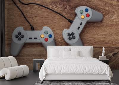 Retro gamepads on a wooden floor. Top view Wall mural