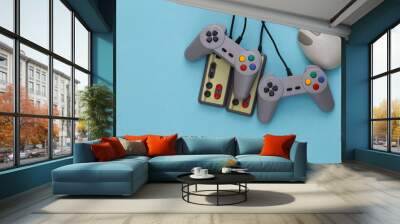 Retro joysticks and pc mouse on blue background. Retro gaming, gaming devices, gadgets Wall mural