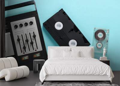 Retro media on a blue background. Old audio cassette player, video and audio tapes.  Top view Wall mural