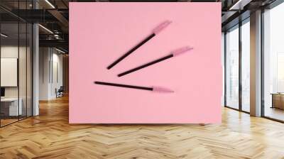 Set of brushes for combing eyelashes on pink background. Beauty concept Wall mural