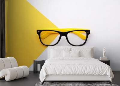 Stylish fashion eyeglasses on a yellow white background. Top view Wall mural