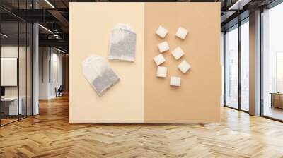 Tea bags and sugar cubes on beige brown background Wall mural