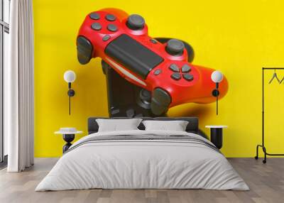 Two gamepad on yellow background close up. Wall mural