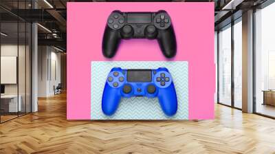 Two Gamepads on pink background. Gaming, leisure and entertainment concept. Top view Wall mural