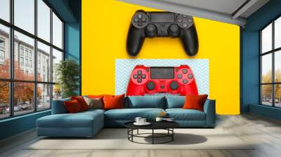 Two Gamepads on yellow blue background. Gaming, leisure and entertainment concept. Top view Wall mural