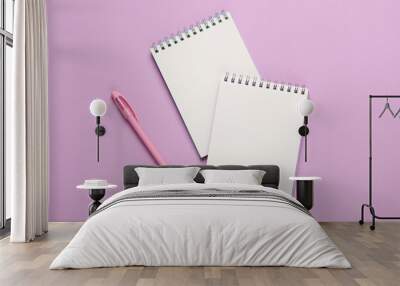 Two white blank notepads with pen on a pastel background Wall mural