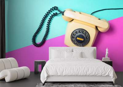 Vintage phone on a blue pink neon surface. Top view. Pop colors. Communication 80s. Flat lay.
 Wall mural