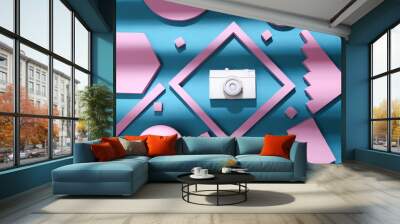 White film camera with pink geometric shapes on a blue background with trendy striped shadow. Creative layout. Top view Wall mural