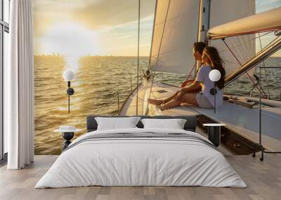 Hispanic couple relaxing on private yacht at sunrise Wall mural