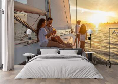 Hispanic family relaxing on luxury yacht at sunset Wall mural