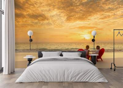 Senior couple enjoying beach vacation at sunset Bahamas Wall mural