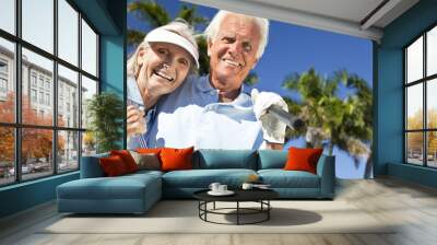 happy senior man & woman couple playing golf Wall mural