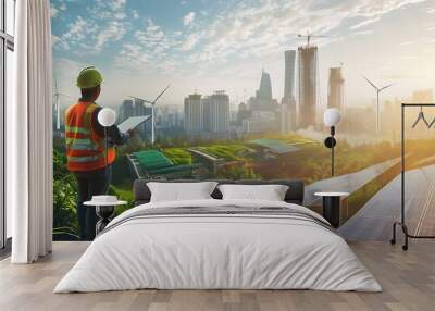 Construction worker overlooking a modern city with wind turbines and solar panels. Wall mural