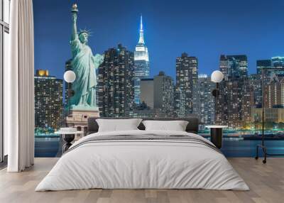 The Statue of Liberty with cityscape in Manhattan at night, New York City, USA Wall mural