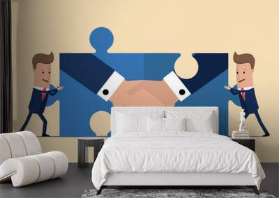 two businessmen holding puzzle elements with a handshake. partnership concept. symbol of a successfu Wall mural