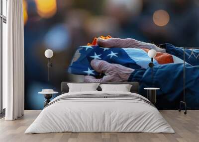 Veteran Holding Folded American Flag During Veterans Day Memorial Service with Blurred Crowd Wall mural