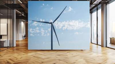 Wind turbine generate electricity on blue sky background. Energy conservation concept. Producing alternative energy Wall mural