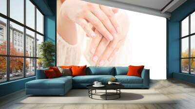 Womans hands with beautiful manicure on white background. Closeup shot of womans hands in a nail salon Wall mural