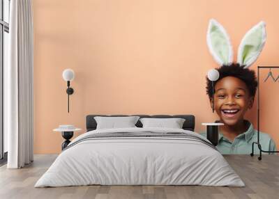 black boy with bunny ears smiling on studio background Wall mural