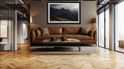 A large black blank picture frame hangs over a large brown sofa, mockup, horizontal, landscape format Wall mural