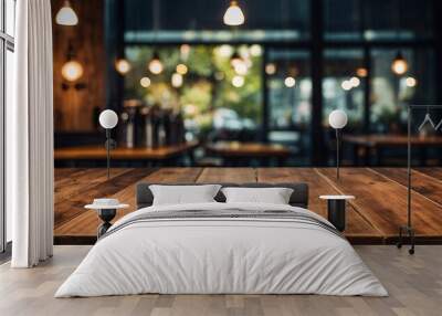 Empty wooden table in front of abstract blurred background for product display in a coffee shop Wall mural