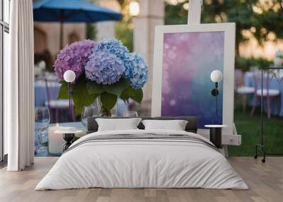 White blank horizontal poster on easel in front of wedding reception tables with pastel blue and purple colors hydrangea flowers Wall mural