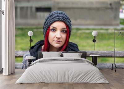 Homeless girl, Young beautiful red hair girl sitting alone outdoors with hat and shirt feeling anxious and depressed after she became a homeless person close up portrait Wall mural