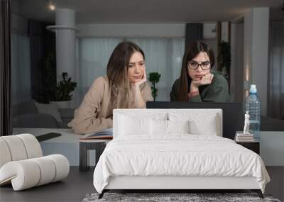 Two young woman freelancers business owners colleagues and roommates developing their online business company web site for online shopping. Creative females working on interior design project. Wall mural