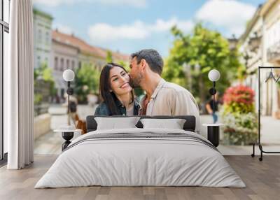 Young happy couple in love exchanging looks in the city street. Man and woman, people in relationship outdoor. Modern alternative carefree couple travelers and tourists vacation destination. Wall mural