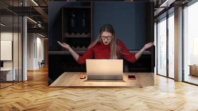 Young tired business woman working from home office because of tiredness she is nervous and annoyed, she is stressed and bothered by slow internet and error in computer program on laptop Wall mural