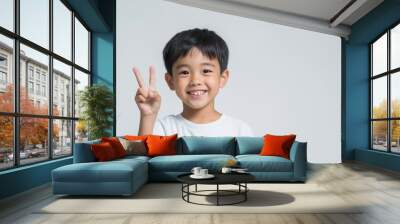 Asian boy with two fingers hand sign Wall mural