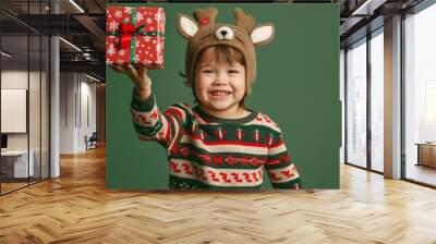 children in a deer hat and Christmas costume smiling Wall mural