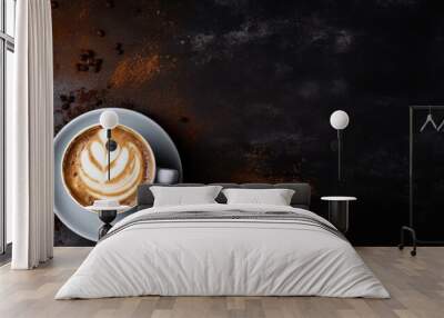 Glass filled with latte and delicately sprinkled with cinnamon rests against a black background. Wall mural