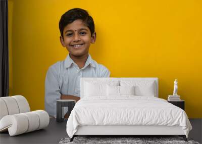 Young Indian school kid isolated on colour background Wall mural