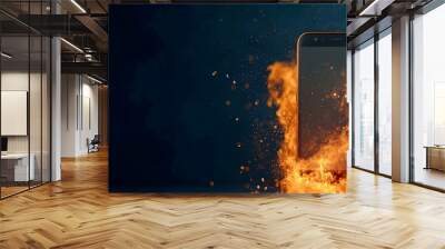 Close up view of a smartphone engulfed in flames with an intense burst of fire and sparks erupting from the device against a fast paced blurred digital backdrop creating a dramatic and dynamic scene Wall mural